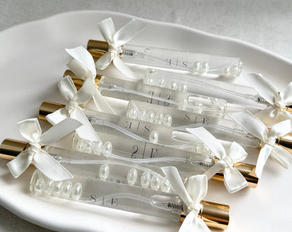 Cologne spray bottles favors with pearls.